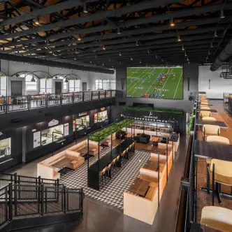 Modern sports bar interior with large TV screen and open seating layout